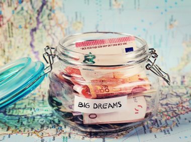 Piggy bank on travel tourist map. Saving money for travel, planning holiday or vacation